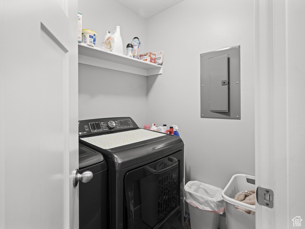 Washroom with laundry area, washing machine and dryer, and electric panel