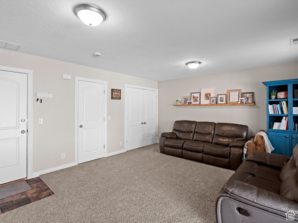 Living area featuring carpet floors, baseboards, and visible vents