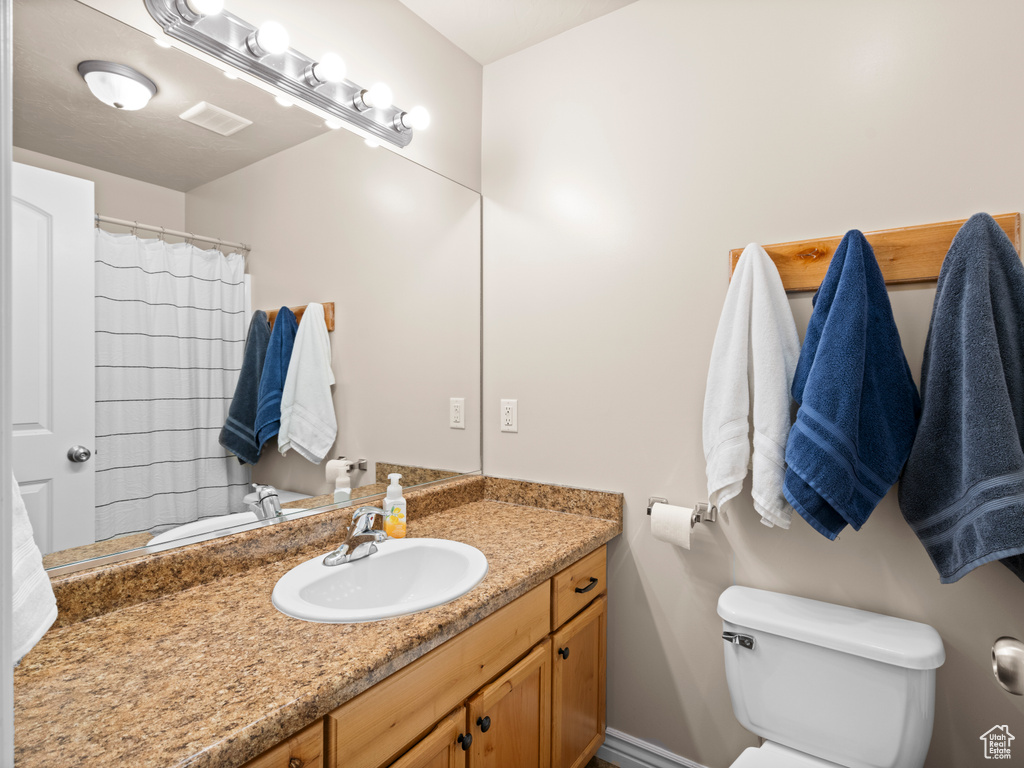 Bathroom featuring vanity and toilet