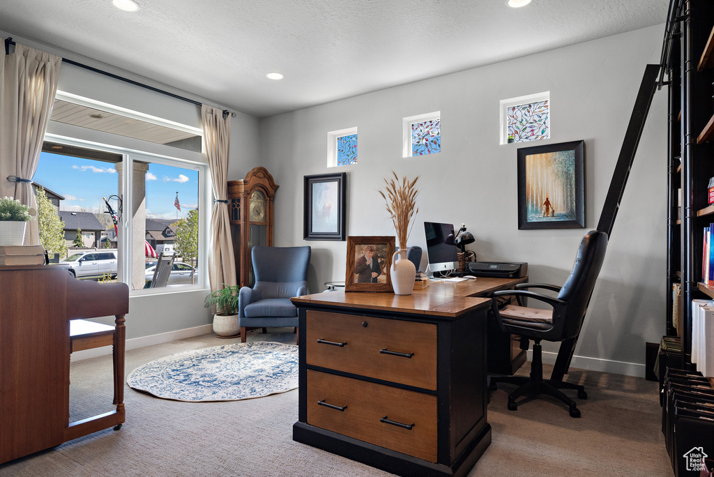 Carpeted office space with recessed lighting and baseboards