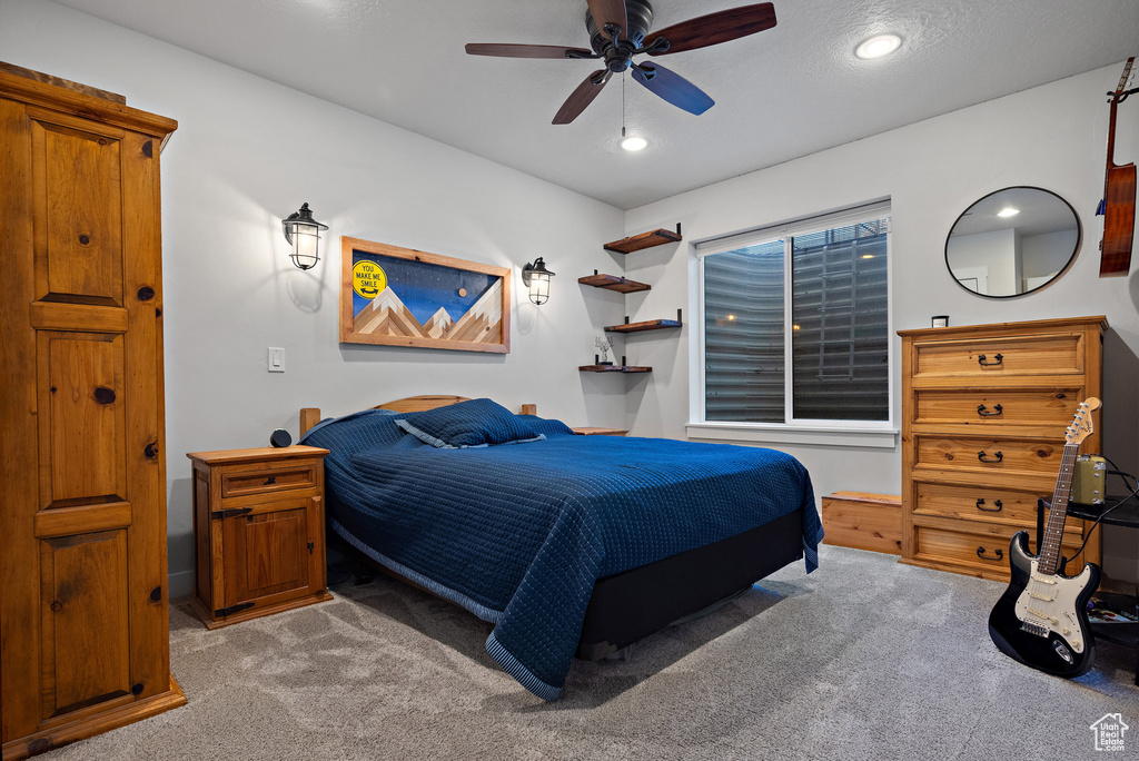 Carpeted bedroom featuring recessed lighting and a ceiling fan