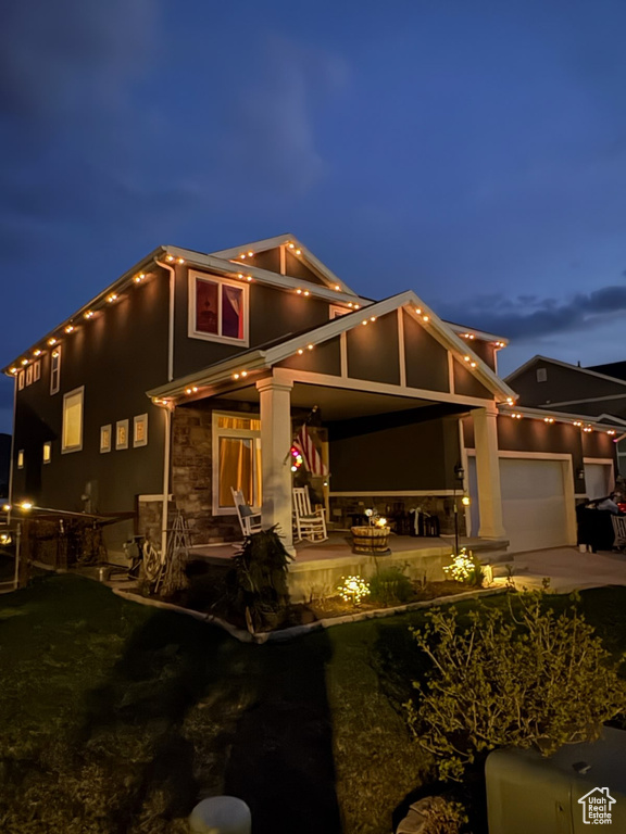Craftsman inspired home with a garage, a patio, stucco siding, and driveway