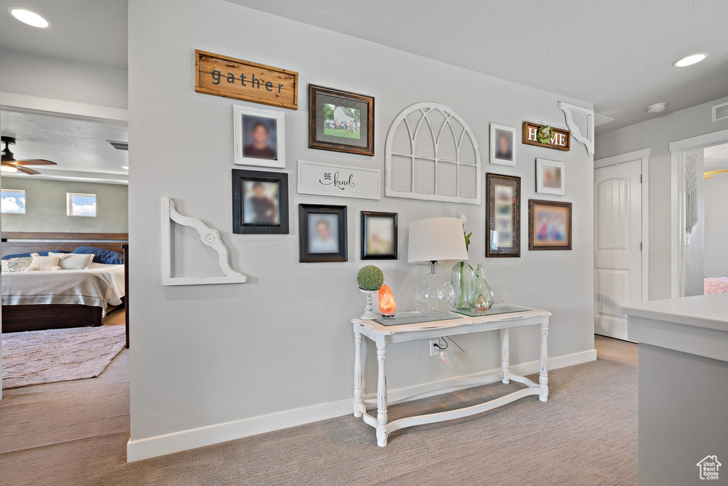 Hallway featuring carpet floors, recessed lighting, baseboards, and visible vents