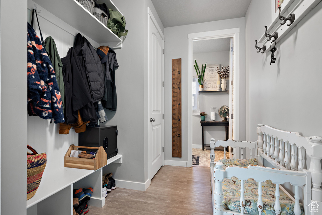 Mudroom with baseboards and wood finished floors