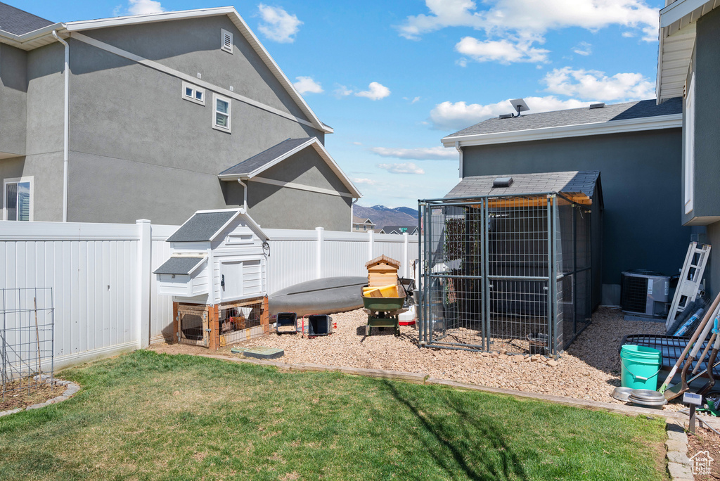View of yard featuring exterior structure, cooling unit, and an outdoor structure