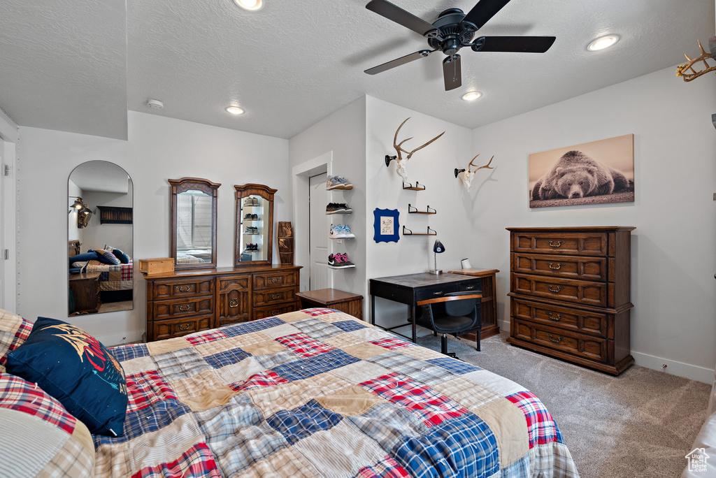 Carpeted bedroom featuring recessed lighting, arched walkways, baseboards, and ceiling fan