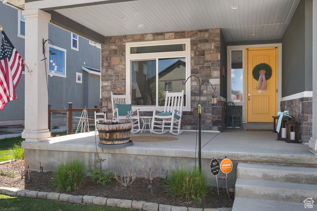 Exterior space with a porch and stone siding