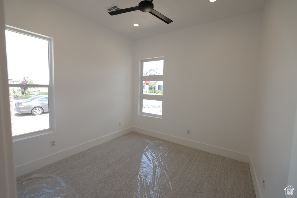 Empty room featuring visible vents, baseboards, ceiling fan, recessed lighting, and light colored carpet