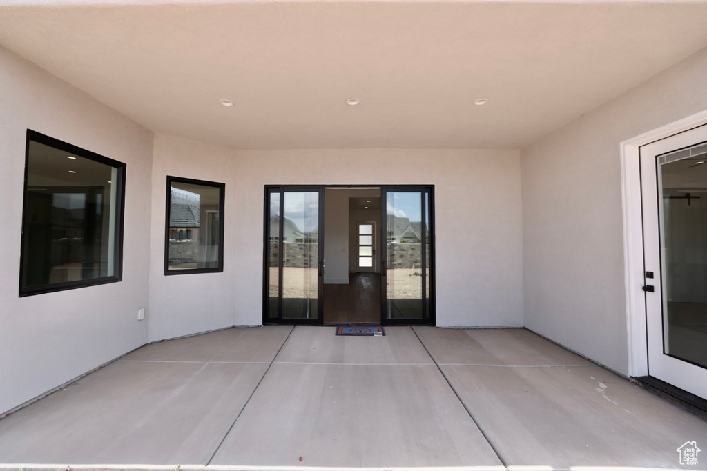 Property entrance featuring a patio area and stucco siding