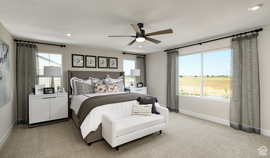 Bedroom featuring a ceiling fan, baseboards, light colored carpet, and recessed lighting