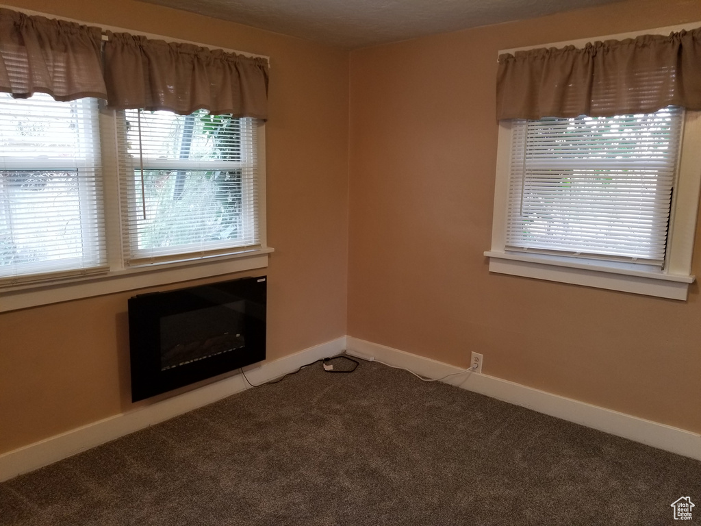 Carpeted spare room with baseboards