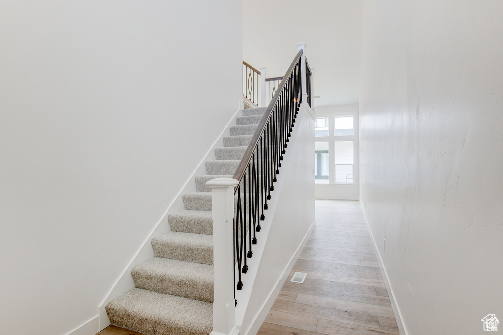 Stairs with baseboards and wood finished floors