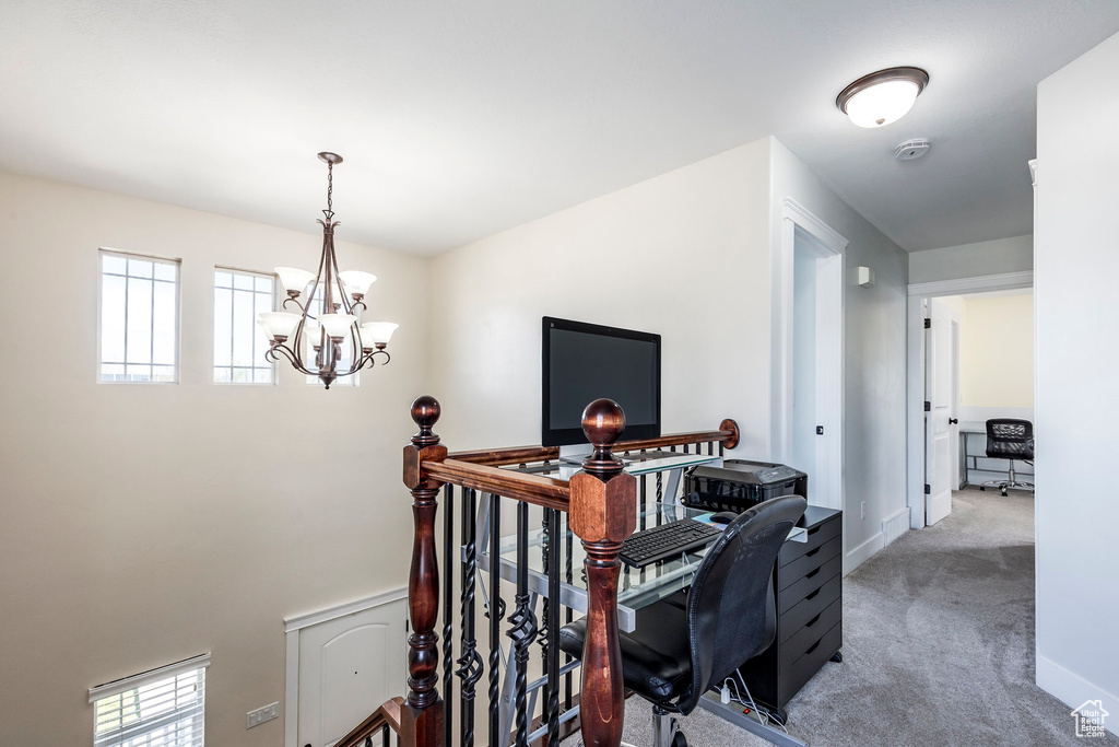 Office with baseboards, carpet flooring, and a notable chandelier