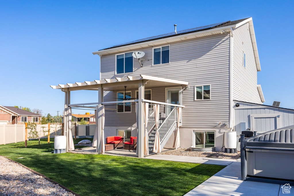 Rear view of property featuring a patio area, fence, a yard, a pergola, and stairs
