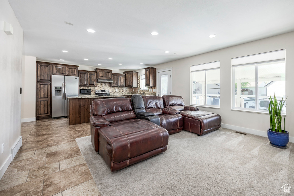 Living area featuring baseboards, recessed lighting, and visible vents