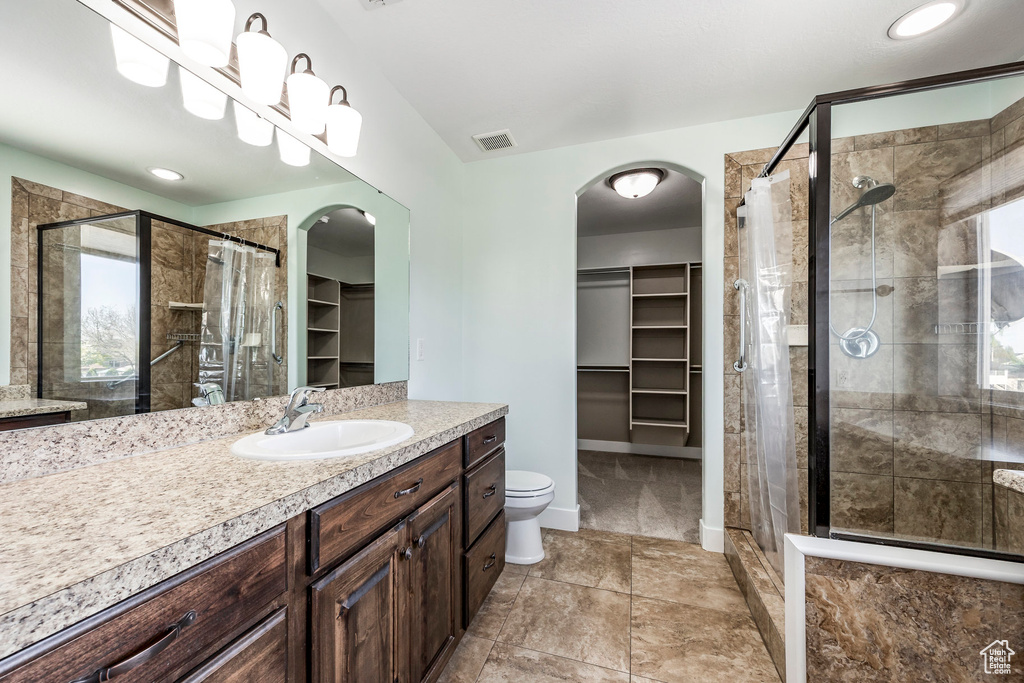 Bathroom with visible vents, a stall shower, and a spacious closet