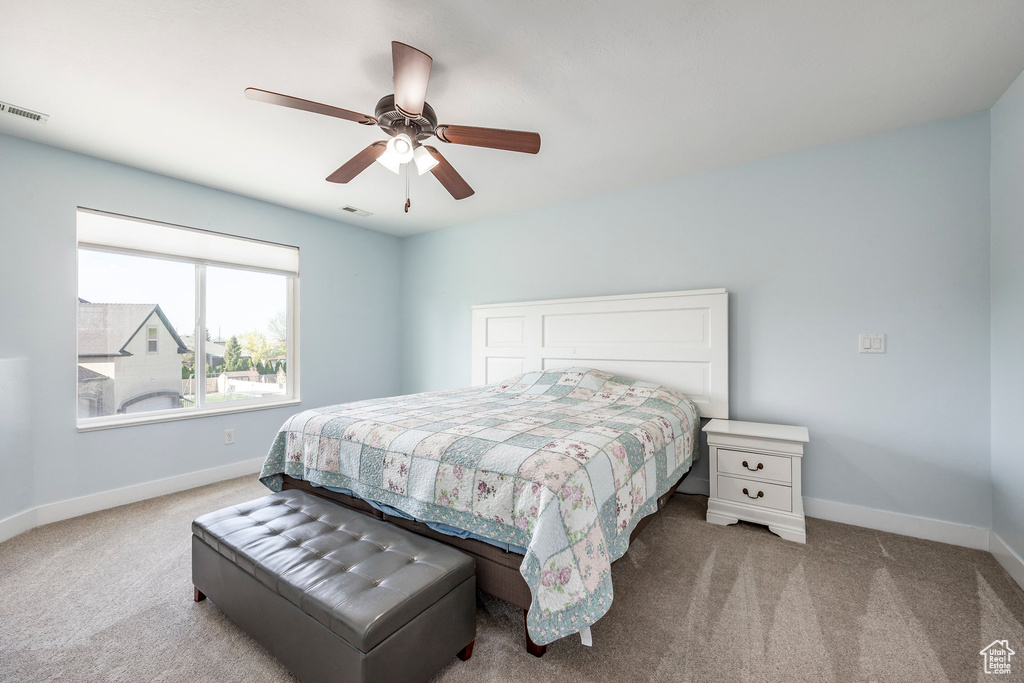 Bedroom featuring baseboards, carpet, and visible vents