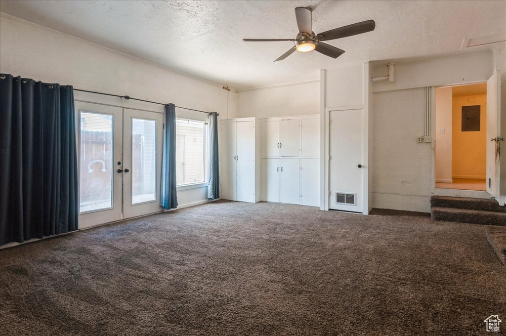 Unfurnished bedroom with electric panel, french doors, visible vents, access to exterior, and carpet