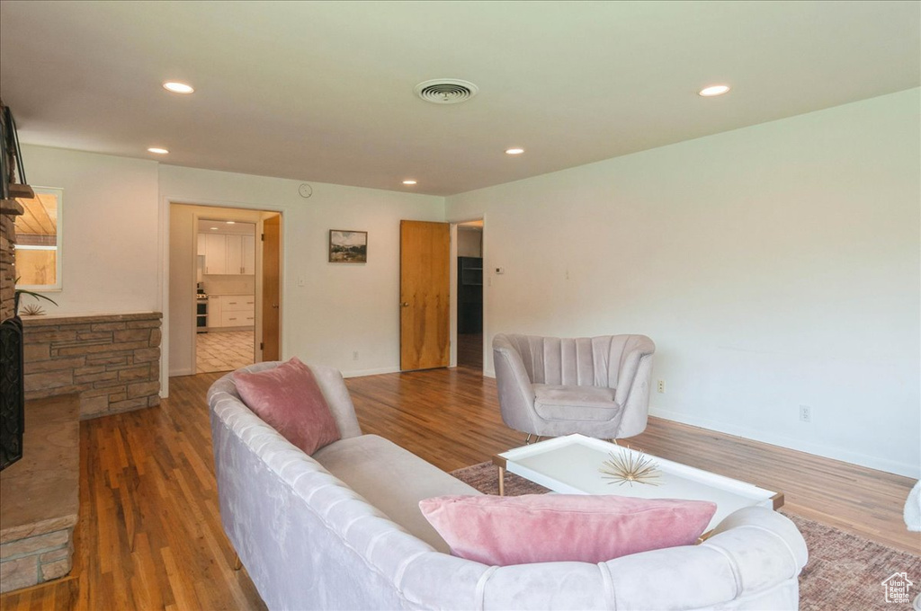 Living area featuring recessed lighting, visible vents, and wood finished floors