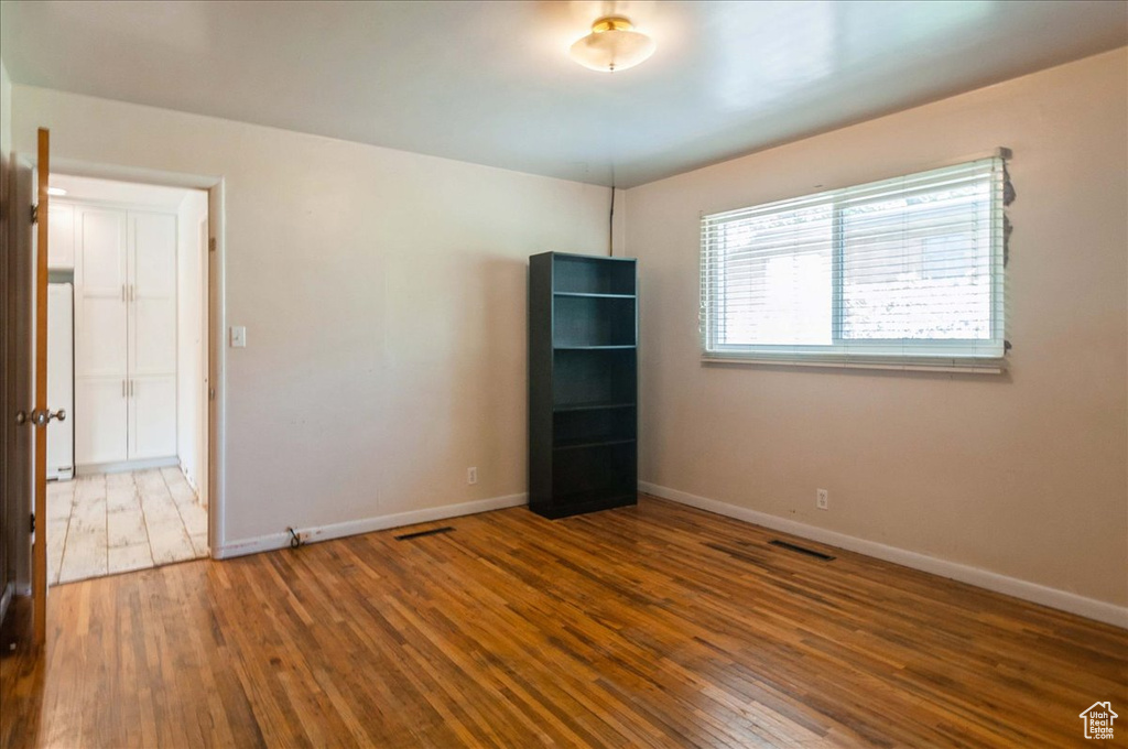 Unfurnished room featuring wood-type flooring and baseboards
