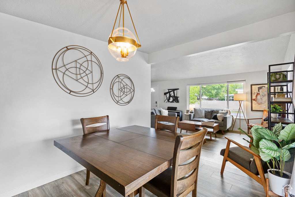 Dining space with baseboards and wood finished floors