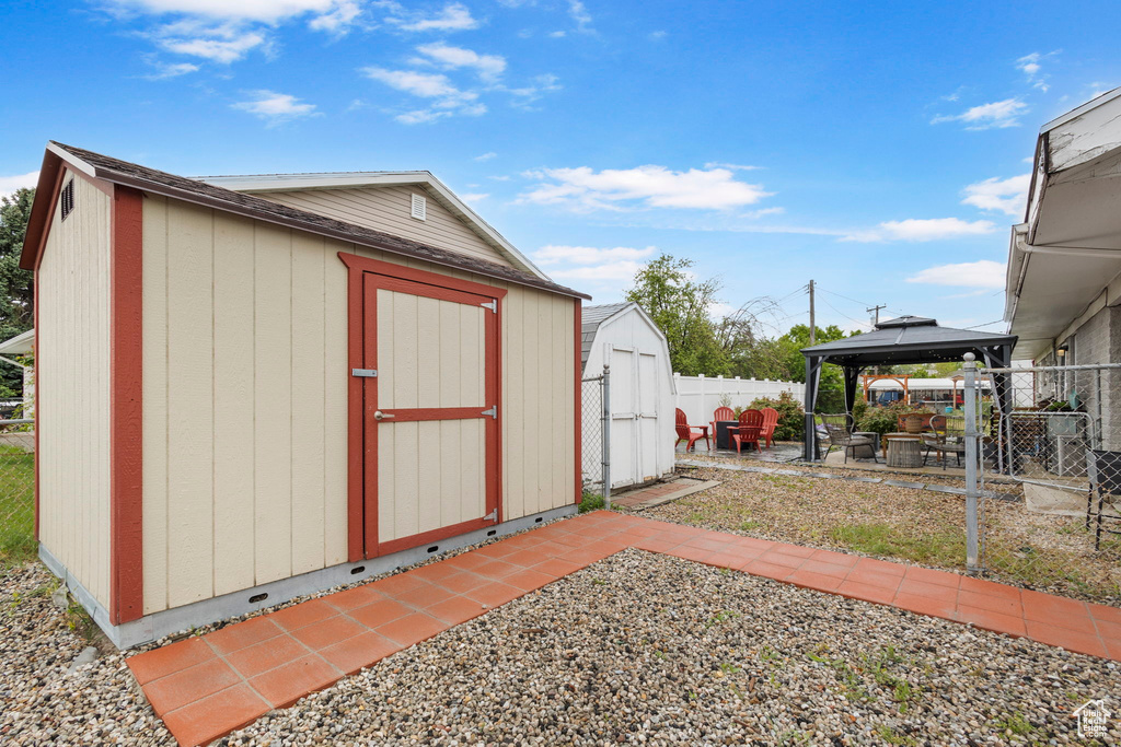 View of shed with a gazebo and a fenced backyard