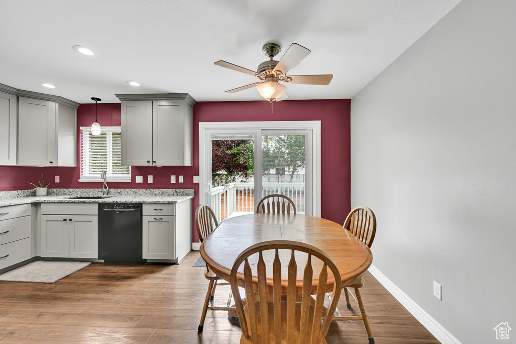 Kitchen with a sink, ceiling fan, dishwasher, and a wealth of natural light