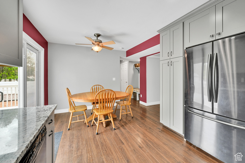 Dining area with baseboards, ceiling fan, and wood finished floors