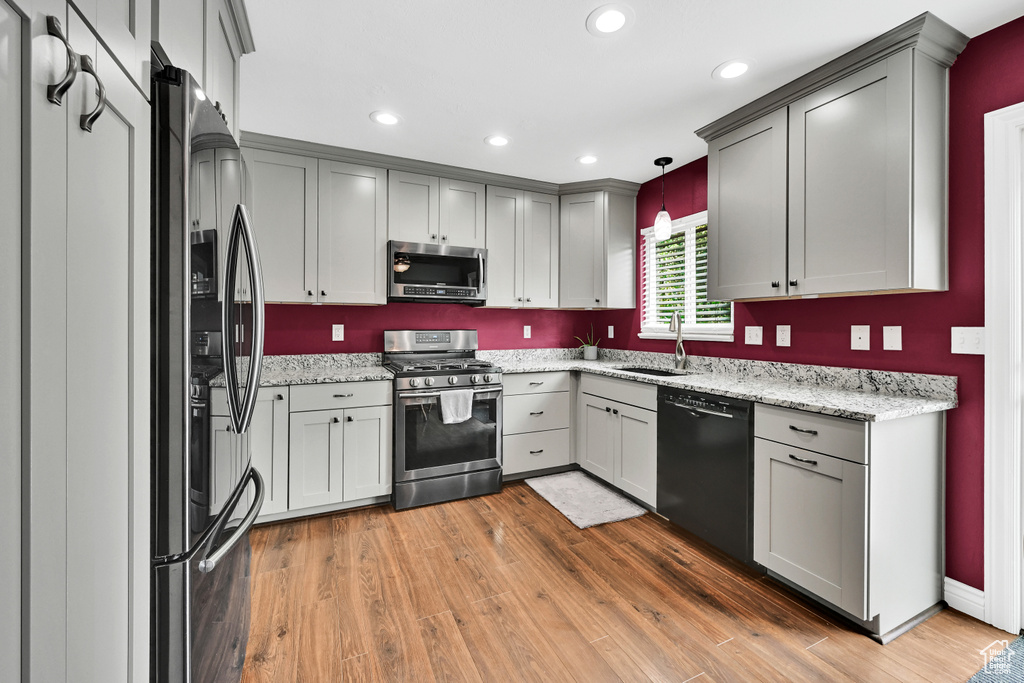 Kitchen with a sink, recessed lighting, stainless steel appliances, and light wood finished floors