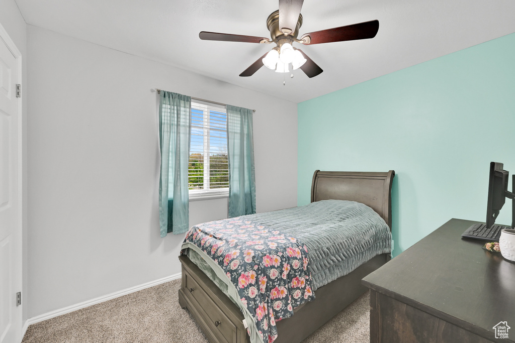 Bedroom featuring carpet flooring, a ceiling fan, and baseboards