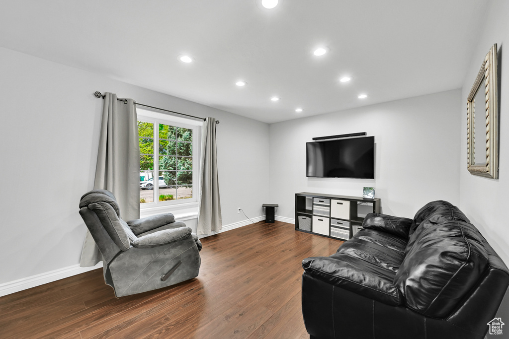 Living room with baseboards, recessed lighting, and wood finished floors