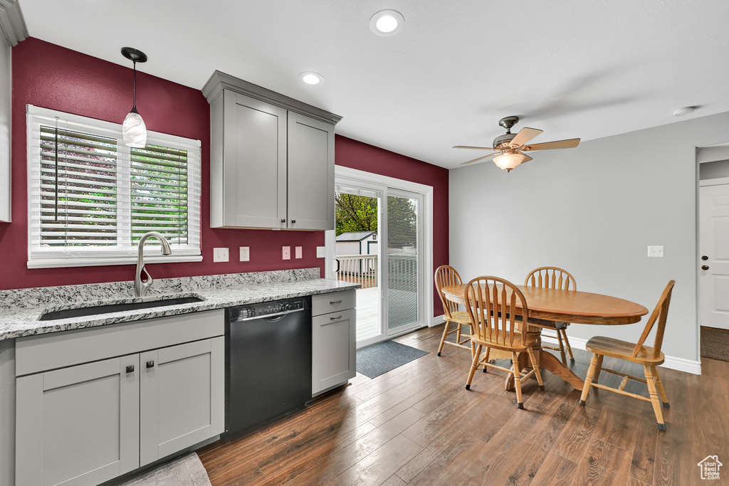 Kitchen with a ceiling fan, dark wood-style flooring, pendant lighting, a sink, and dishwasher