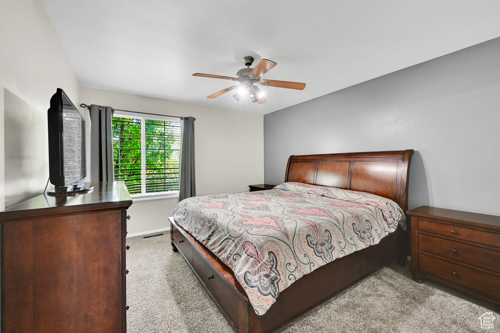 Bedroom featuring carpet floors, a ceiling fan, baseboards, and visible vents