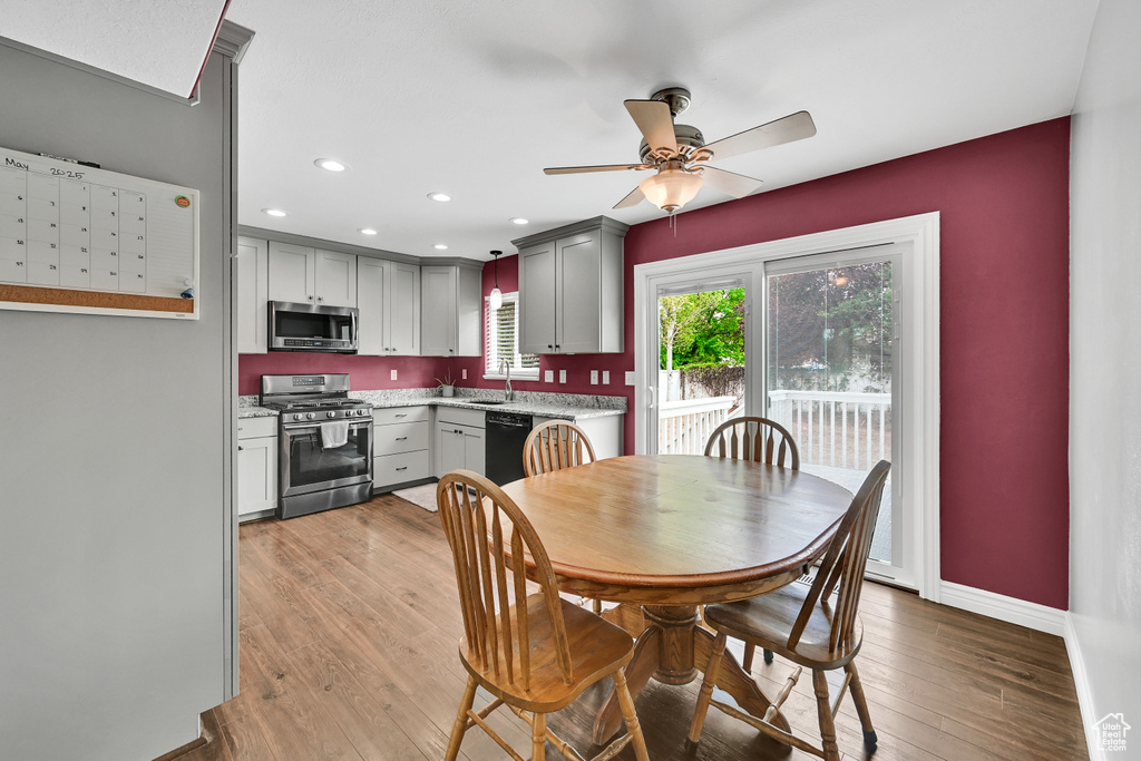 Dining room featuring light wood-style floors, a ceiling fan, baseboards, and recessed lighting