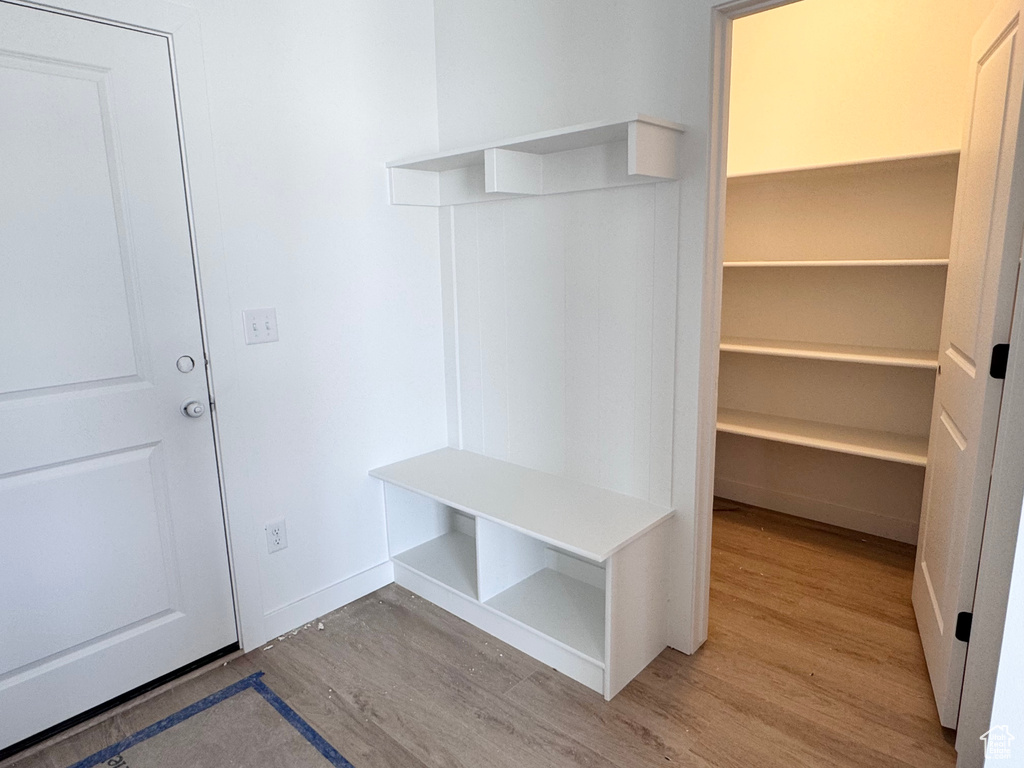 Mudroom with baseboards and wood finished floors