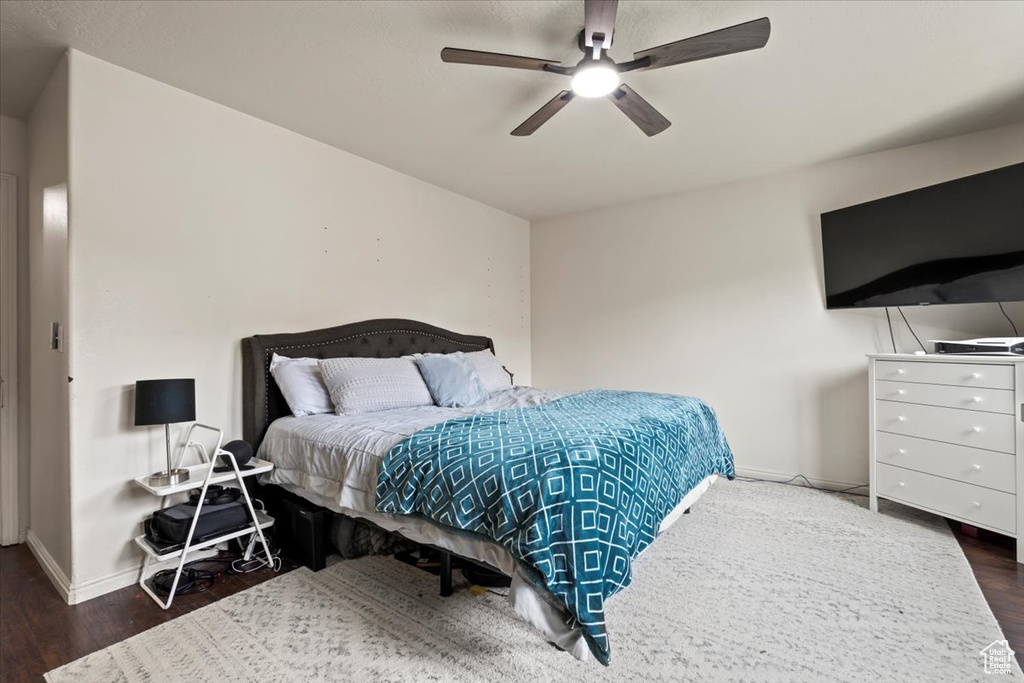 Bedroom with baseboards, a ceiling fan, and wood finished floors