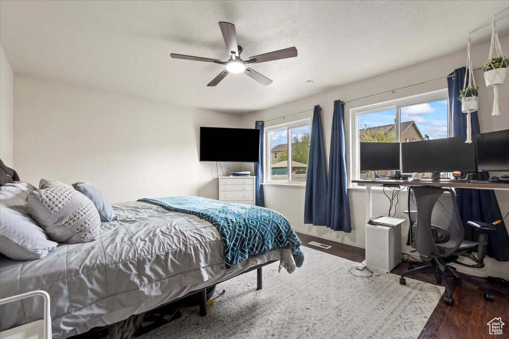 Bedroom with baseboards, ceiling fan, and wood finished floors