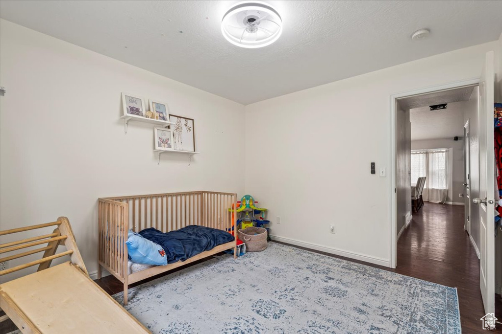 Bedroom with baseboards and wood finished floors