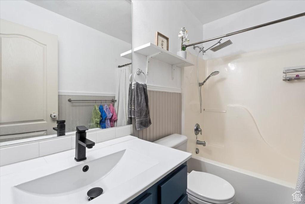 Full bathroom featuring visible vents, a wainscoted wall, toilet, and vanity