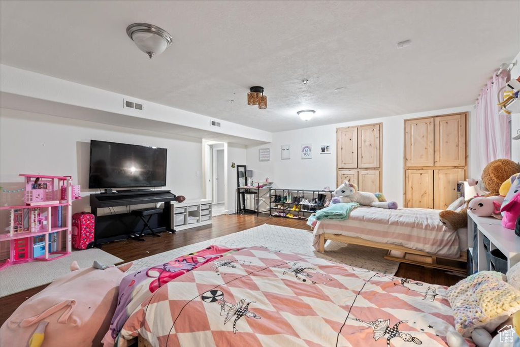 Bedroom with visible vents and wood finished floors