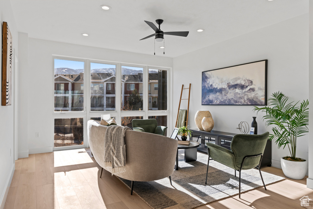 Living area featuring recessed lighting, light wood-style flooring, ceiling fan, and baseboards
