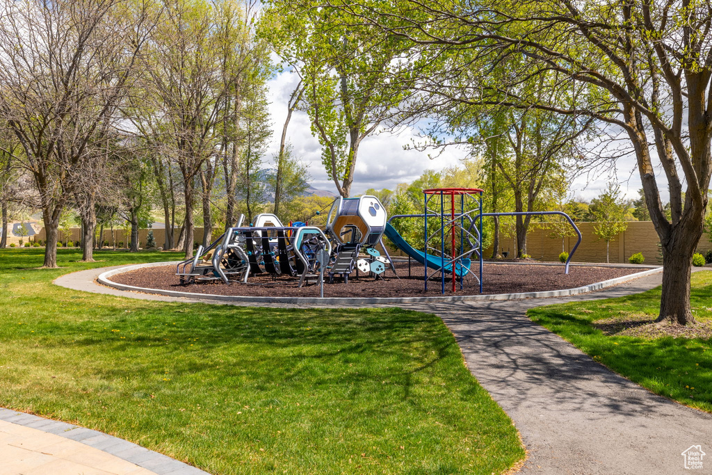 Community jungle gym featuring a lawn