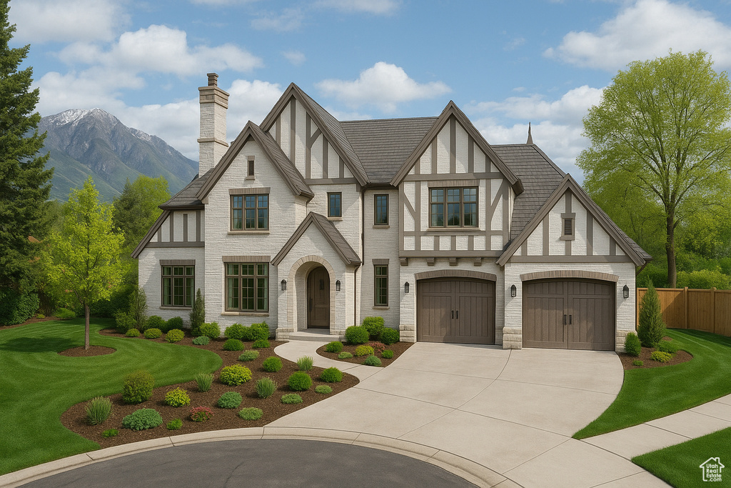 Tudor home with a chimney, a front yard, fence, a mountain view, and concrete driveway