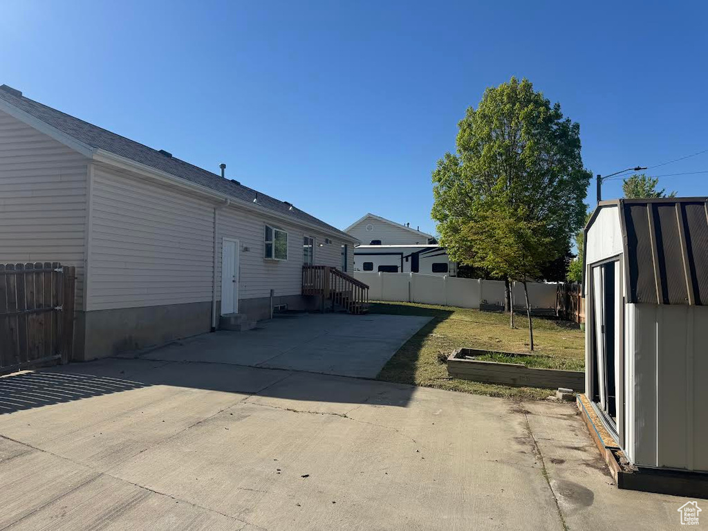Back of property with a patio and fence