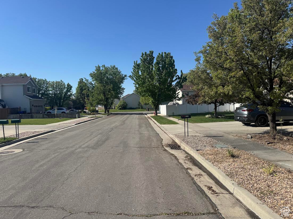 View of road featuring a residential view, sidewalks, and curbs