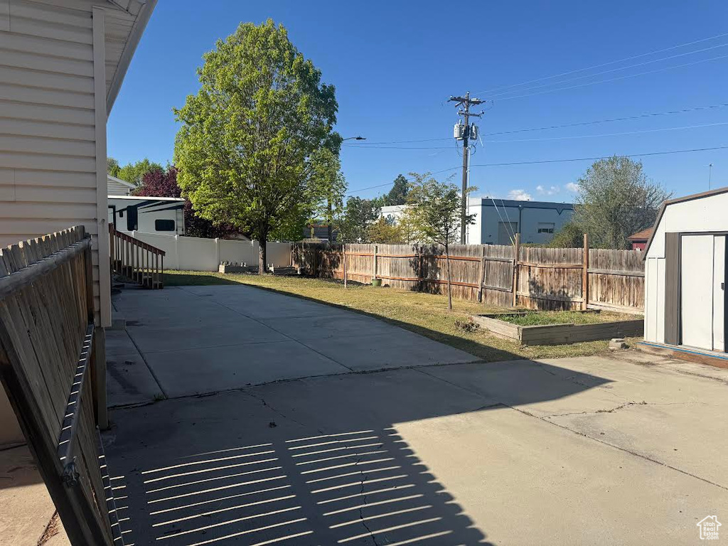 View of pool with a patio, a fenced backyard, a shed, and an outdoor structure