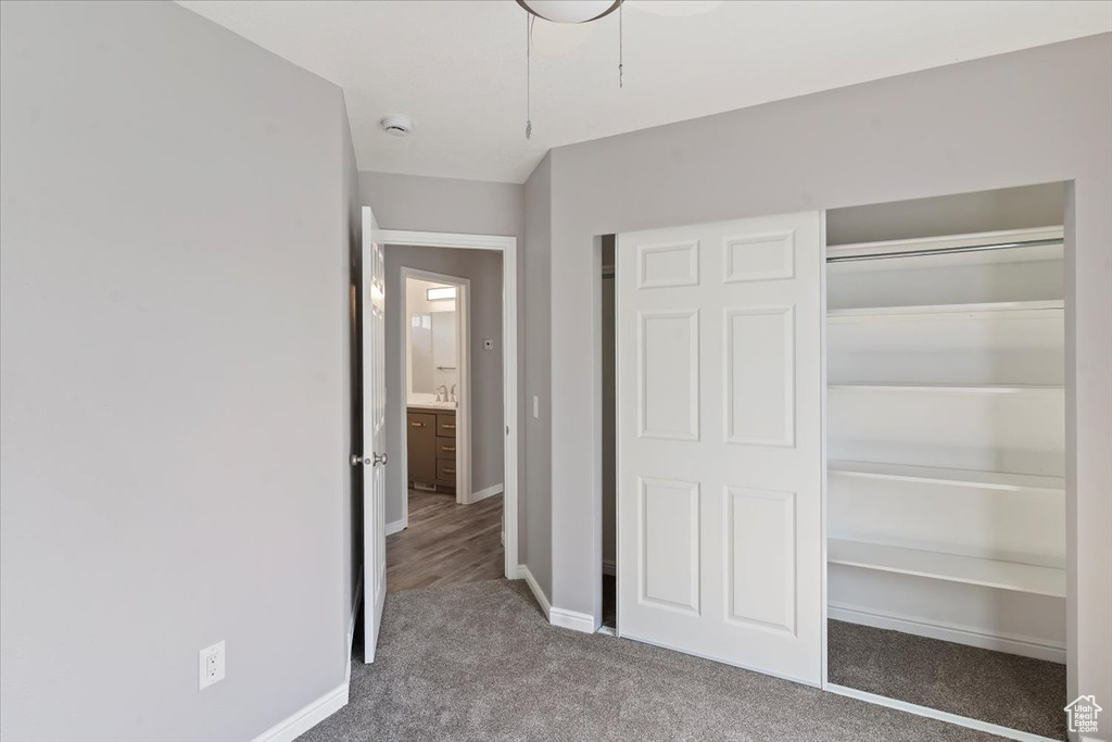 Unfurnished bedroom featuring carpet flooring, a closet, and baseboards