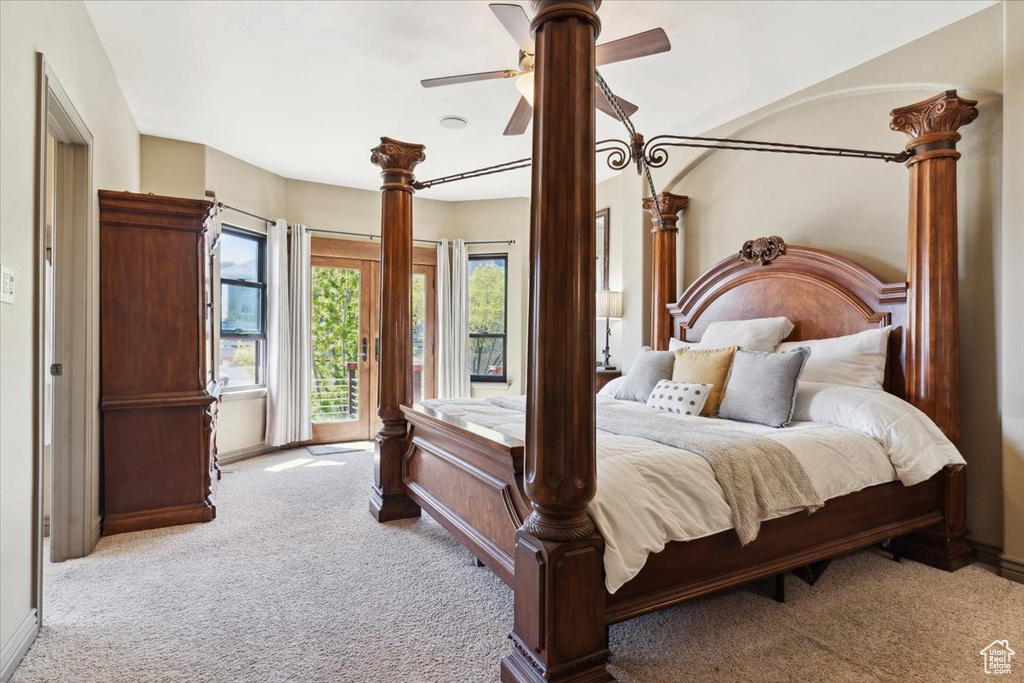 Carpeted bedroom with access to outside, a ceiling fan, and baseboards