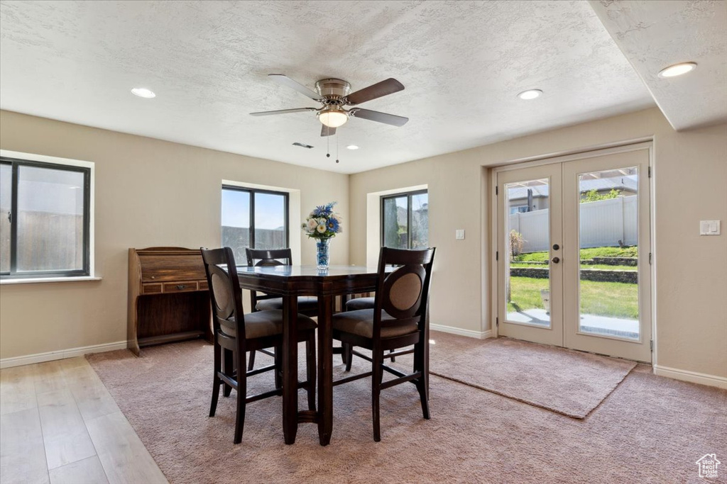 Dining space with baseboards, recessed lighting, a textured ceiling, french doors, and a ceiling fan