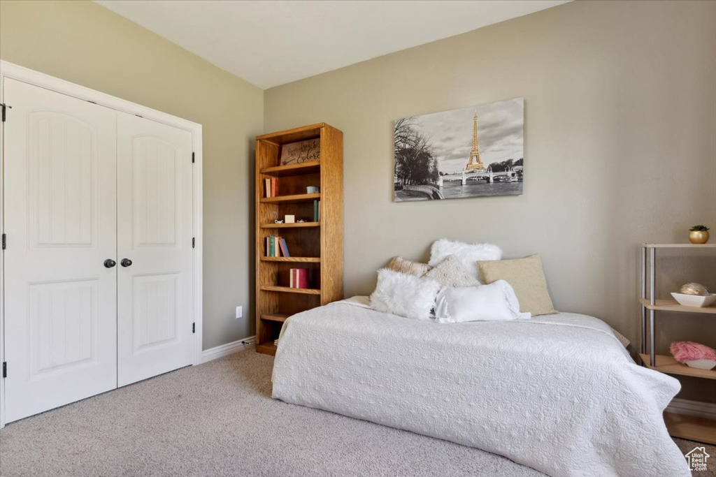 Carpeted bedroom with a closet
